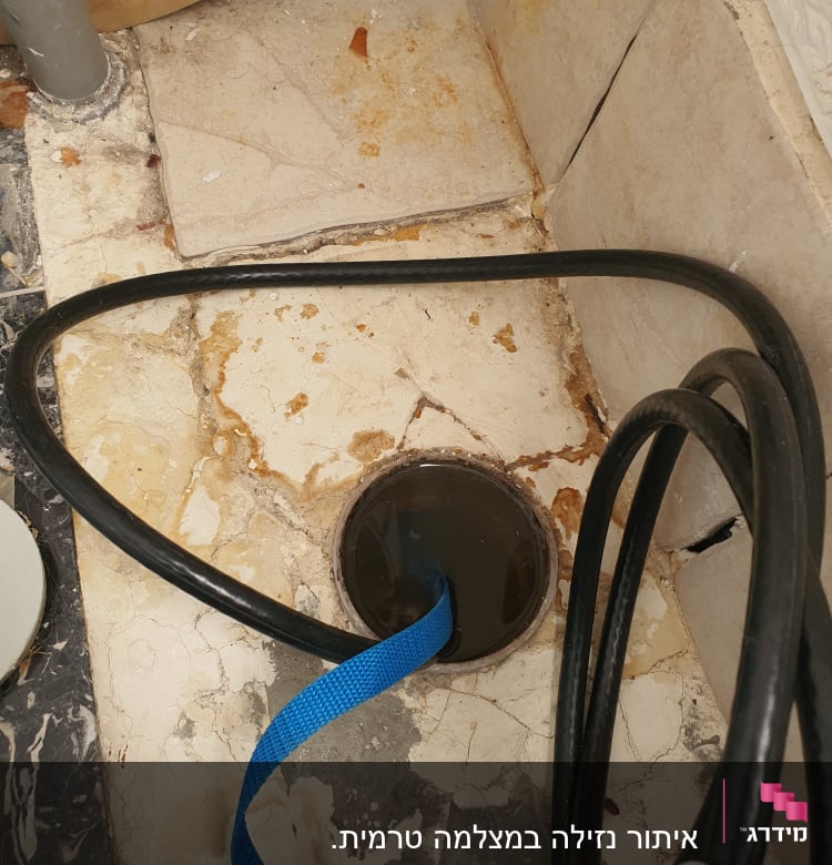 צינור שחור עם רצועה כחולה בפתח ניקוז